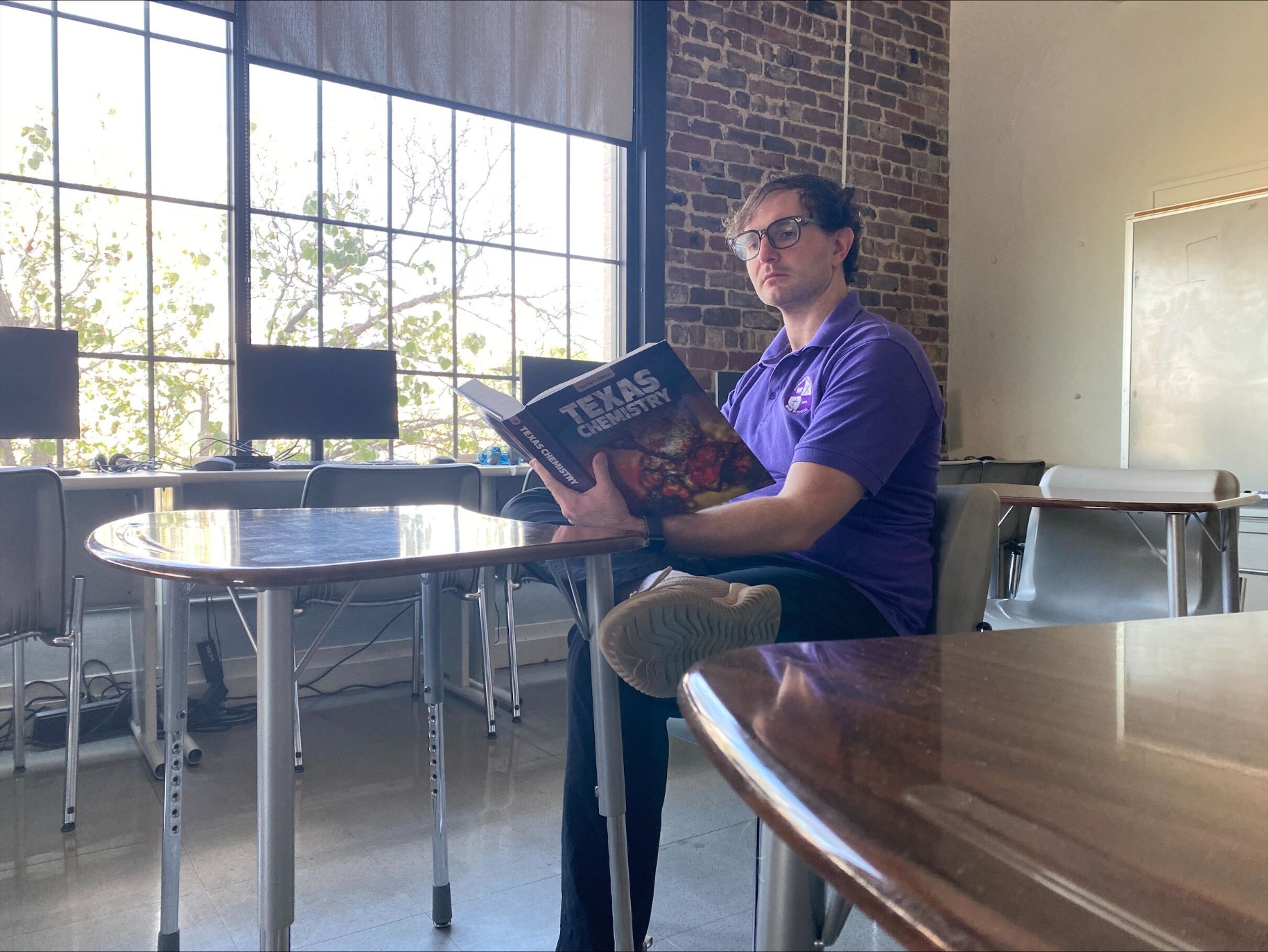 Boaz Goss ’13 reading in his classroom.