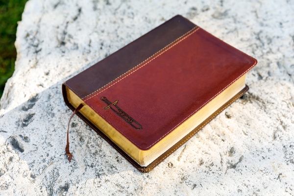 a brown bible on top of a table