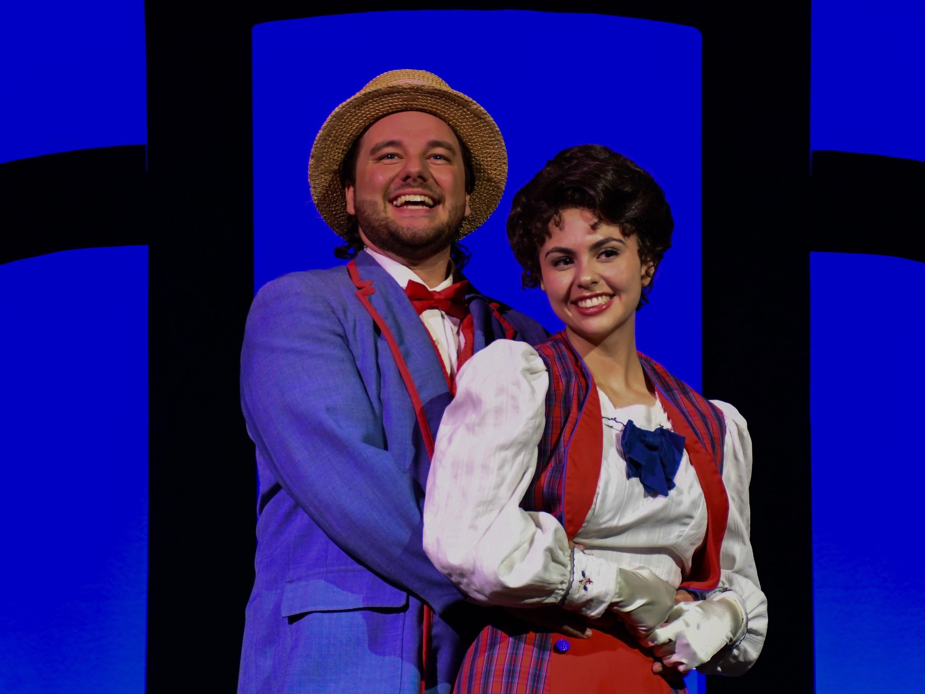 a couple hugging and smiling acting on a theater play